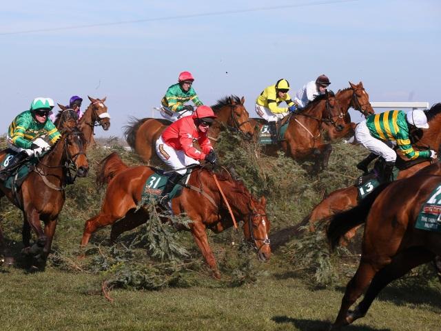 Colbert Station (right) parts company with AP McCoy in the 2013 Grand National